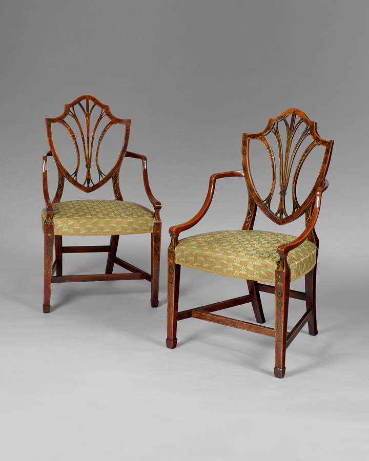 A pair of George III period satinwood shield back armchairs